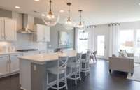 ***Photo from a Riverview model home in another community***  We include pendant lighting over the island, a nice finishing touch for this stunning space.