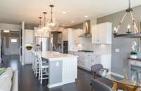 ***Photo from a Riverview model home in another community***  A gas cooktop is included in your Kitchen along with built-in oven and microwave.