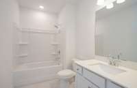 ***Photo taken from a previously built Aspire home with Basement***  Bath #3 is located in the Basement and includes tile flooring and quartz countertops.