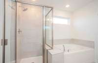 ***Photo taken from a recently completed Hampton home in the community***  The Owner's Bath also includes a tiled garden tub and shower!