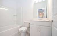 ***Photo taken from a recently completed Hampton home in the community***  A full bathroom is located on the 1st floor next to the guest Bedroom.