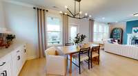 ***Photo taken from the Furman model home in Durham Farms***  The Dining Room opens to be the Kitchen and Great Room, creating a spacious, open concept layout ideal for hosting family and friends.