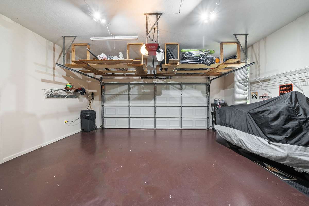 Upstairs attached two-car garage with access door to kitchen