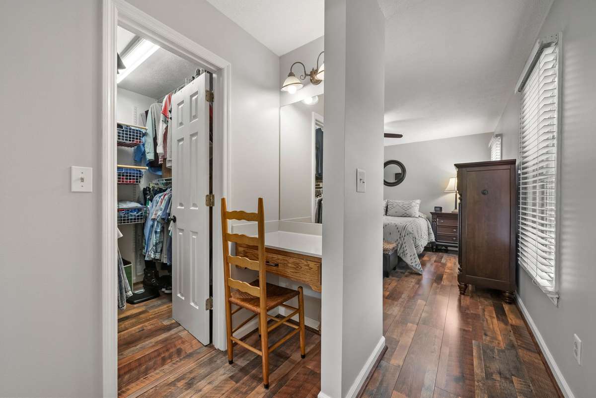Makeup vanity and walk-in closet from primary bedroom on main floor