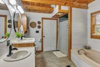 Spacious master bathroom with double vanities, whirlpool tub, shower, and walk-in closet, all ready for your personal touches.