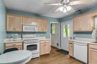 Separate fully equipped kitchen with oven, microwave, dishwasher, and refrigerator.