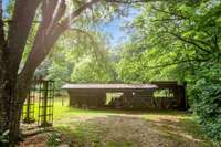 Shed near the home has 4 stalls for horses and a chicken coop.