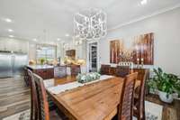 The eat-in area is bright and welcoming, featuring a beautiful chandelier and large windows that flood the space with natural light. 8385 Lascassas Pike Lascassas, TN 37085