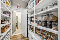 Insanely large walk-in pantry offers incredible storage space, complete with lower drawer cabinets for optimal organization. Tucked at the back, a hidden storm shelter adds both convenience and peace of mind. 8385 Lascassas Pike Lascassas, TN 37085