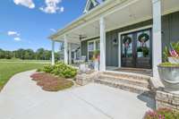 Stunning covered front porch welcomes you with beautiful double front doors and classic brick steps. 8385 Lascassas Pike Lascassas, TN 37085