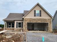 House Features Decorative Stacked Stone on the Front Porch and around the Garage Door.  Picture of Previous House.