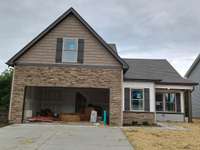 Covered Front Porch and Decorative Stacked Stone on the Front.
