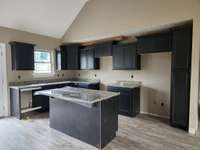 Kitchen has an Abundance of Custom Cabinets and a Large Island.  Picture of Previous House.