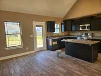 Stainless Smooth Top Stove, Dishwasher and Built-In Microwave are provided. Picture of a Previous House.