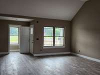 Spacious Living Room with LV Plank Flooring and Vaulted Ceiling. Picture of Previous House.