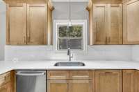 Beautiful natural cabinets and stainless steal appliances complete this gorgeous kitchen