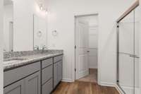 What a fabulous primary bathroom, featuring double vanities, water closet and linen closet!