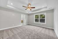 Primary Bedroom features a en-suite bathroom with tile shower, double vanities, and a walk in closet