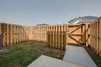 Private outdoor space enclosed by a sturdy wooden fence—perfect for pets, play, or relaxing in peace.