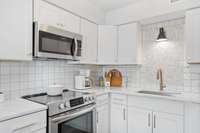 Brand new cabinets, quartz countertops, and incredible tile backsplash