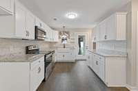 Granite counters, upgraded fixtures, tile backsplash, and the appliances that you see, stay with the home.