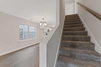 Carpeted stairs leading to the second level of the home.