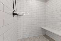 The walk in shower has been upgraded to the seller's taste. They added the tile to the ceiling to prevent mold and damage to the drywall over time. Plus the seat and oil rubbed bronze fixtures are way nicer than builder grade.