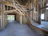 Welcome to elegance -this two-story foyer captivated withs its soaring ceilings, curved staircase and exquisite details.  This home is under construction.  Photo taken 10/1/25