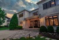 This stunning residence impresses with timeless curb appeal and immaculate landscaping