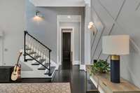 A graceful view into the staircase highlights its custom railing and elegant lines, creating a striking architectural focal point that seamlessly connects the home’s beautifully designed living spaces.