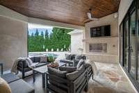 From the covered back deck, enjoy a sweeping view of the resort-style spa and pool area, complete with ceiling fans and a cozy outdoor fireplace — the perfect setting for year-round relaxation and entertaining.