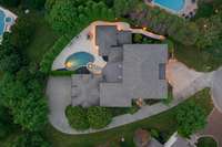 An elegant aerial perspective showcases the home’s impressive footprint, manicured grounds, and serene placement within the exclusive McGavock Farms community — a private retreat surrounded by mature trees and luxury estates.