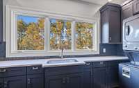 An impressive upstairs laundry room equipped with two sets of washer and dryers, offering exceptional capacity and efficiency — perfect for a busy household or effortless entertaining prep.