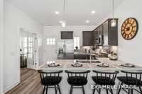 The open-concept kitchen features a bar with ample space for dining & lots of cabinet space.