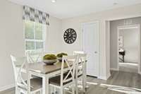 The dining room has ample room for a table that seats 6, with a pantry for storage.