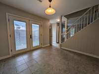 Dining area from the kitchen high-top bar looking toward the front door and living area...