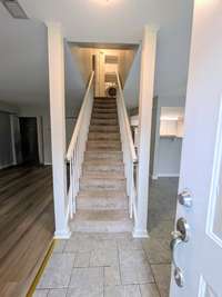 Foyer area with semi-open concept living space...