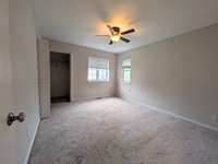 Bedroom 1 with corner windows and large "L"-shaped closet...