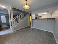 Dining area looking toward kitchen, living area and half-bath on the back hallway...