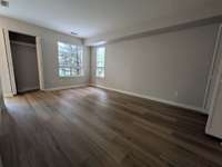 Living area view looking toward front yard and entry door, includes coat closet...