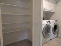 Second floor landing includes linen closet and laundry area...