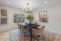 A wide window fills the dining room with natural light.