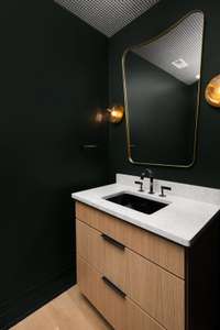 Second chic powder room on the main level with a stylish vanity and sink—perfectly designed for guests and everyday elegance.
