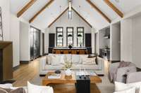 Spacious living room with soaring vaulted ceilings and an open-concept layout that flows seamlessly into the kitchen—perfect for modern living and effortless entertaining.