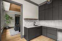 Well-appointed butler’s pantry with sink, second dishwasher, and ice maker—designed for seamless prep and elevated entertaining- sits perfectly between the dining room and kitchen.