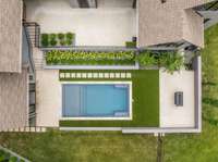 Aerial view of the beautifully designed pool and surrounding outdoor space—luxury, privacy, and serenity all in one stunning setting.