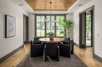 Light-filled dining room featuring an oversized window that brings the outdoors in—ideal for hosting dinner parties or everyday meals with a view. Notice the wood accent ceiling.