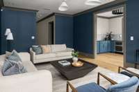 Expansive lower-level bonus room with beautiful wallpaper and a built-in bar area—ideal for hosting, relaxing, or creating the ultimate entertainment space.