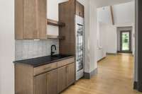Sophisticated wet bar with a Thermador wine fridge just off the kitchen and outdoor living area—perfect for entertaining with style and ease.