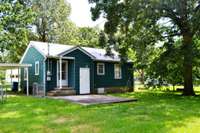 Enjoy this fenced backyard with large trees!